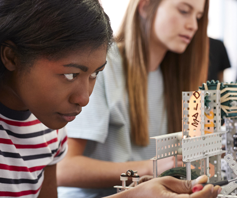 girl working closely with robotics