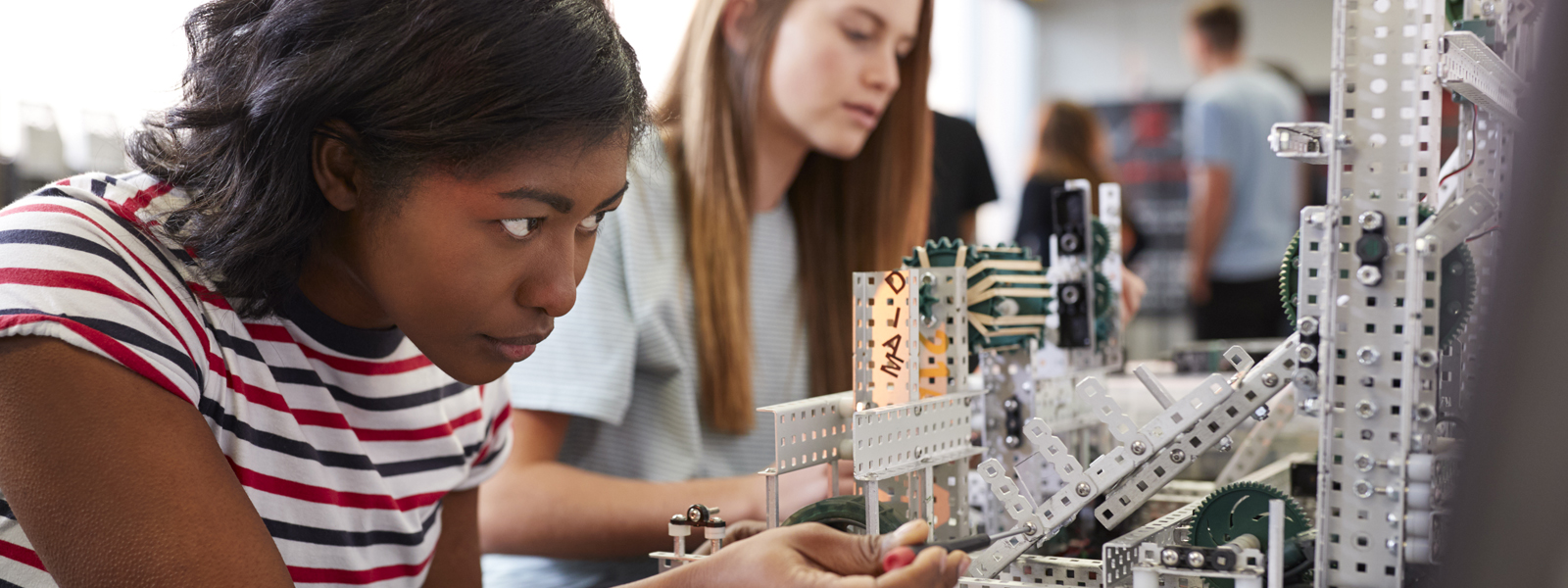girl working closely with robotics