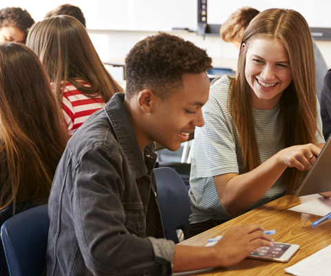 students working in teams, using tablets