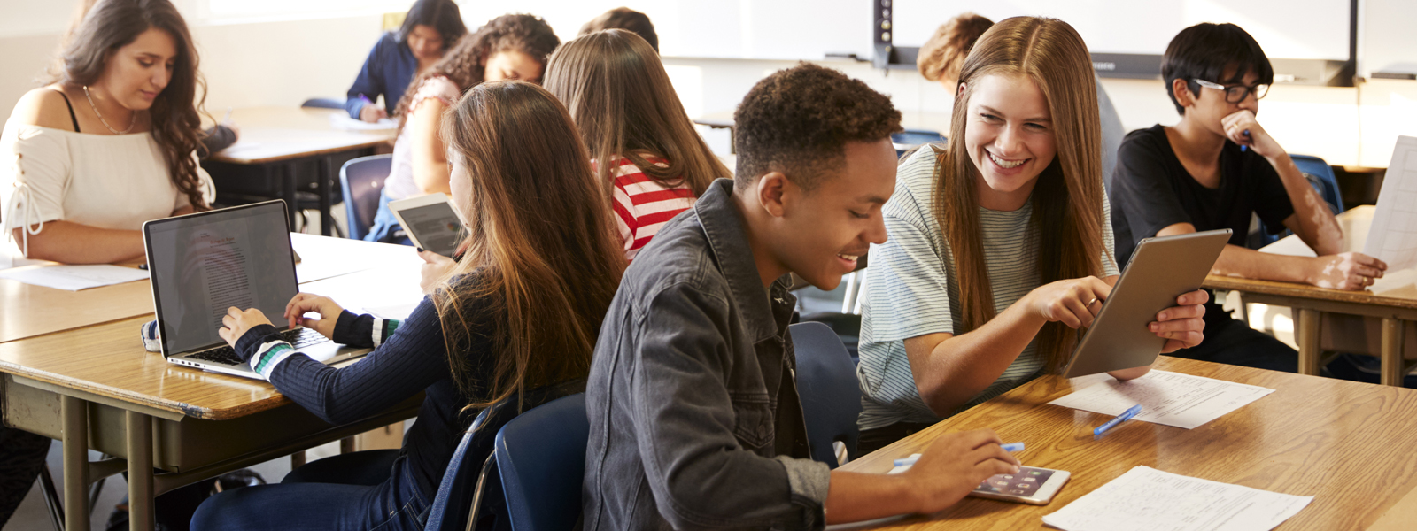 students working in teams, using tablets