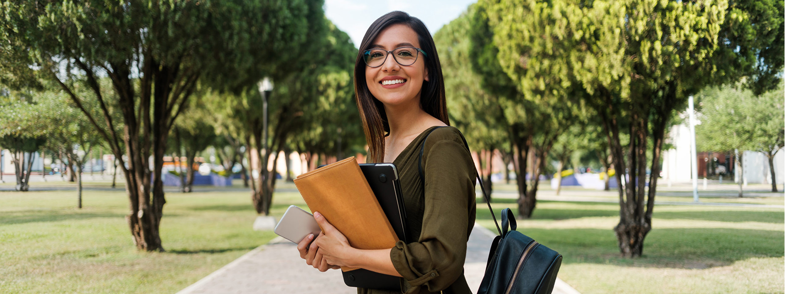 teenage student with backpack on campus