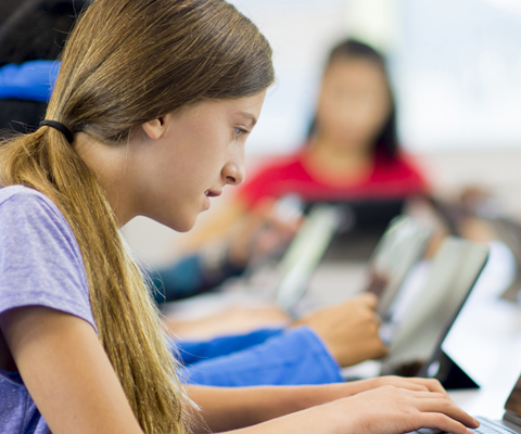 students working individually at a row of workstations