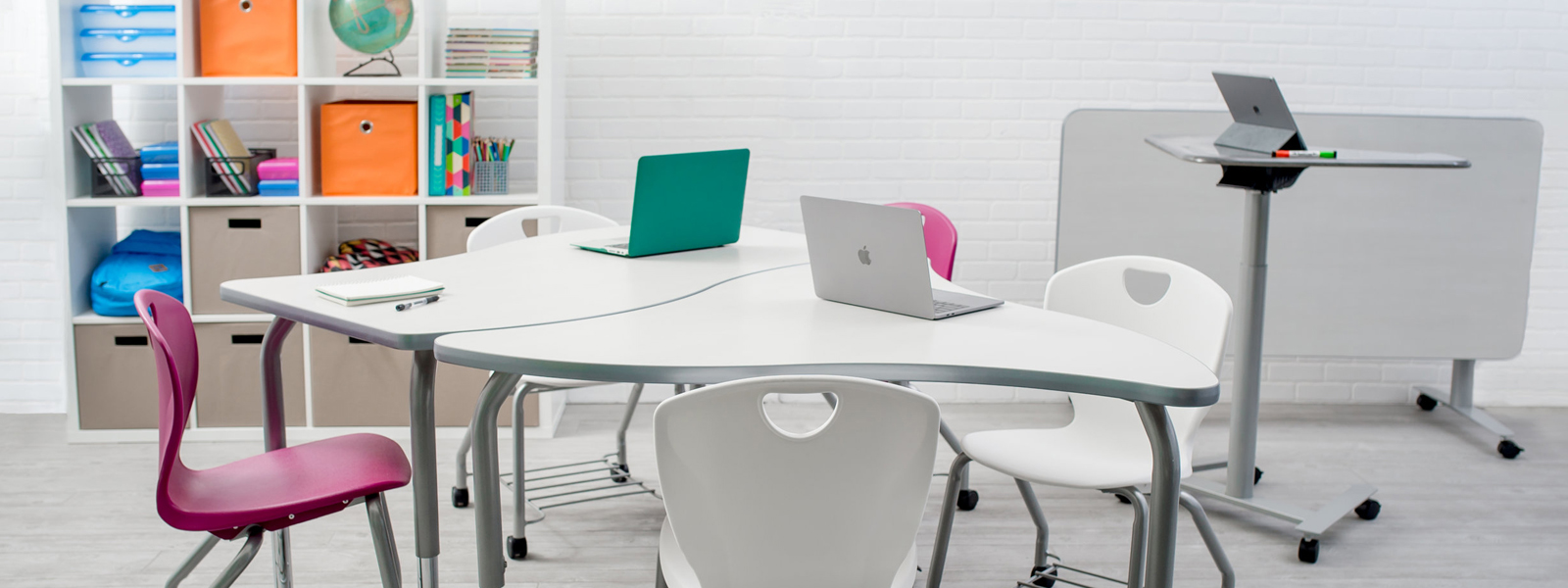 3D rendering of cleanly-designed classroom with laptops and other devices