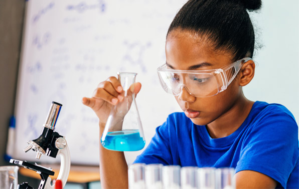student with chemistry beaker