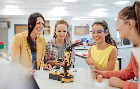 teacher & students working with robotics