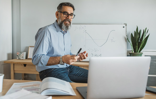teacher on a laptop with videoconferencing