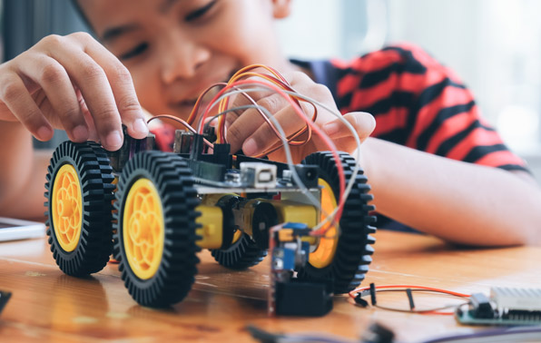 a student working with a robotic vehicle